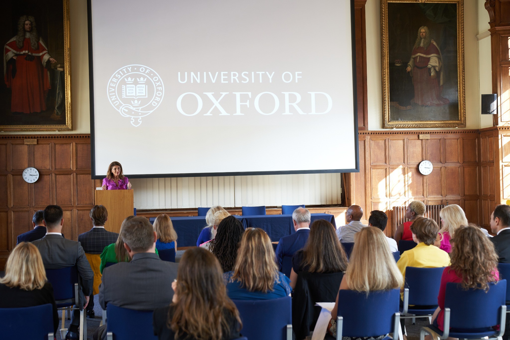 Dr. Dalal Akoury speaking on stage at Oxford